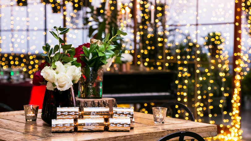 A venue decorated for a corporate holiday party including lights.