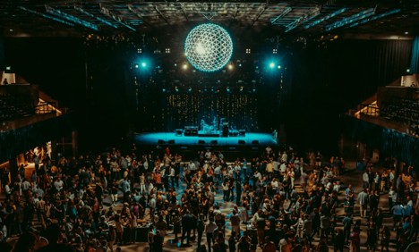 A disco ball suspended over a crowded ballroom.
